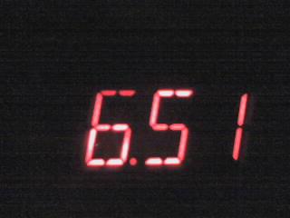 A digital clock showing the time of 6 45
