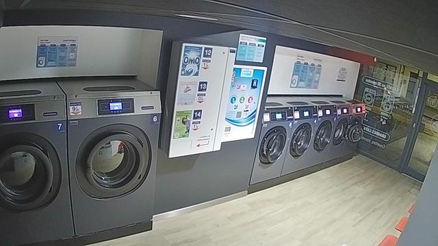A laundry room with washers and dryers in it