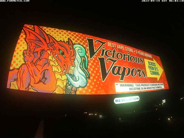 A billboard with a dragon on it in the dark