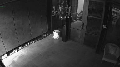 A black and white photo of a room with a door