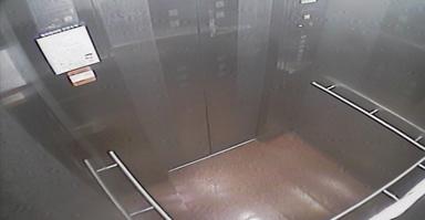 Мужчина с белыми волосами едет в лифте