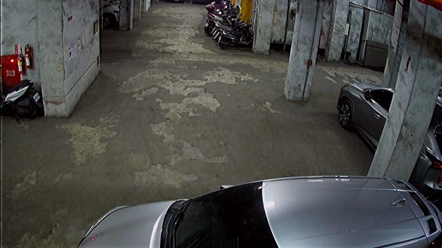 A parking garage filled with lots of parked cars