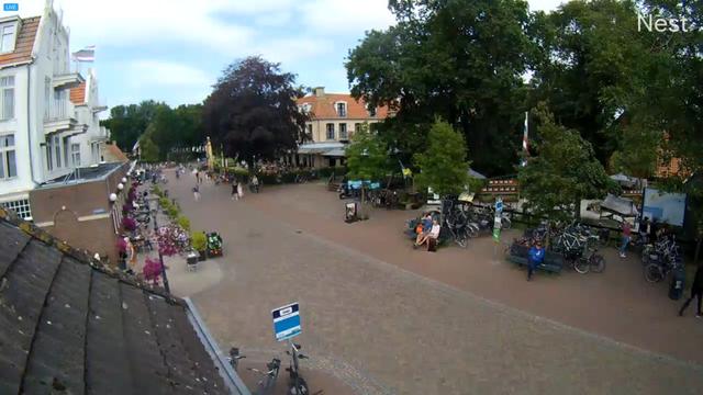 An aerial view of a town square with people and bicycles