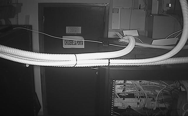 A black and white photo of a cable connected to a computer