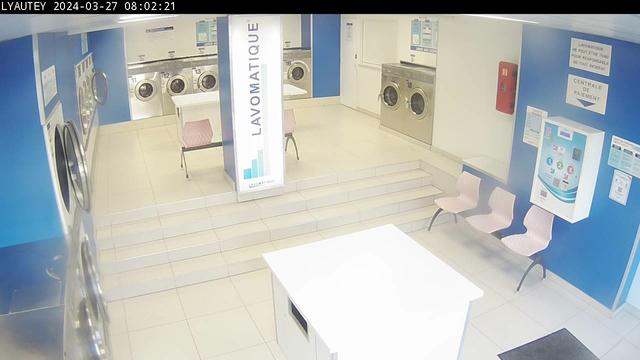 A fisheye view of a laundry room with a washer and dryer