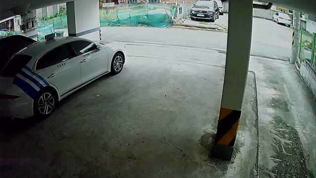 A car is parked in a parking garage