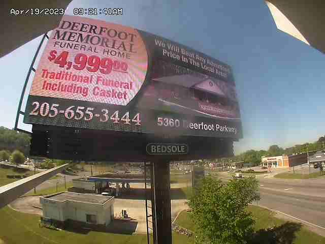 A billboard advertising a funeral in a parking lot