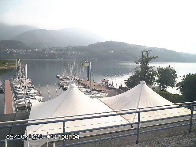 A large white tent next to a body of water