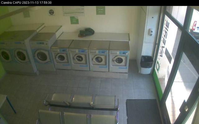 A row of washers in a public laundment