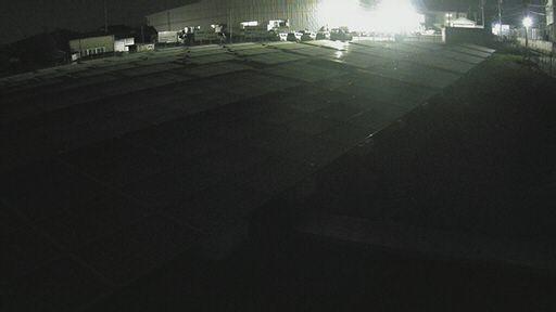 A dark picture of a parking lot at night