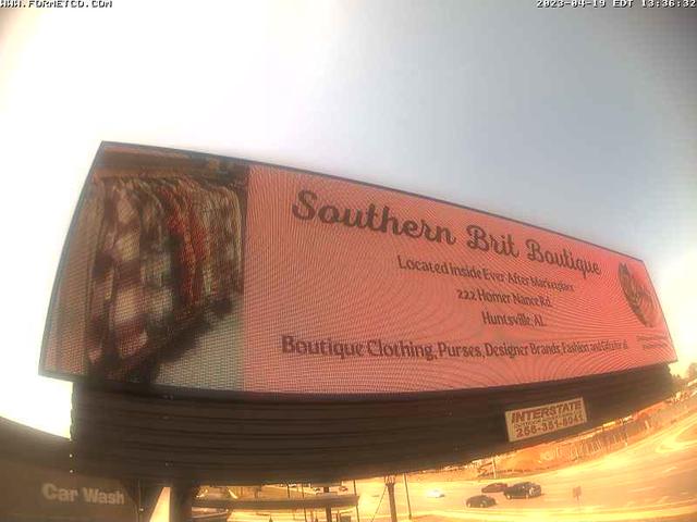 A billboard with a quilt hanging from it's side