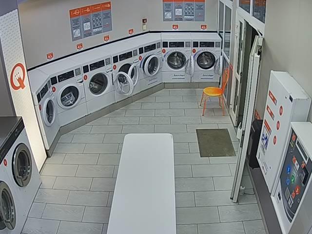 A room that has a bunch of washing machines in it