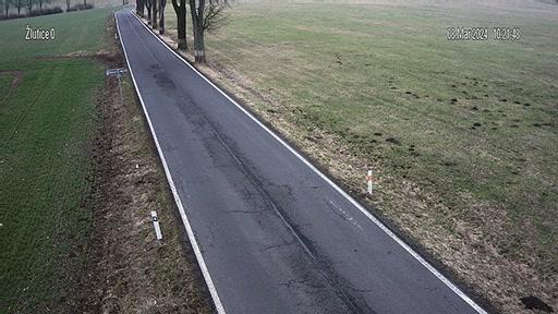 An aerial view of a road in the middle of a field