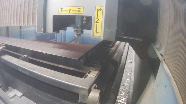 A machine that is cutting a piece of metal