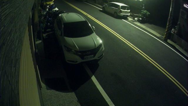 A car driving down a street at night