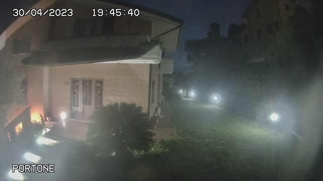 A webcam image of a house at night