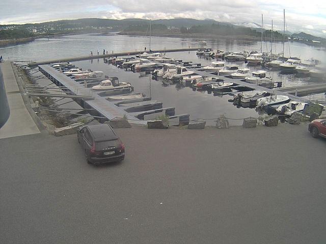 A parking lot filled with lots of boats