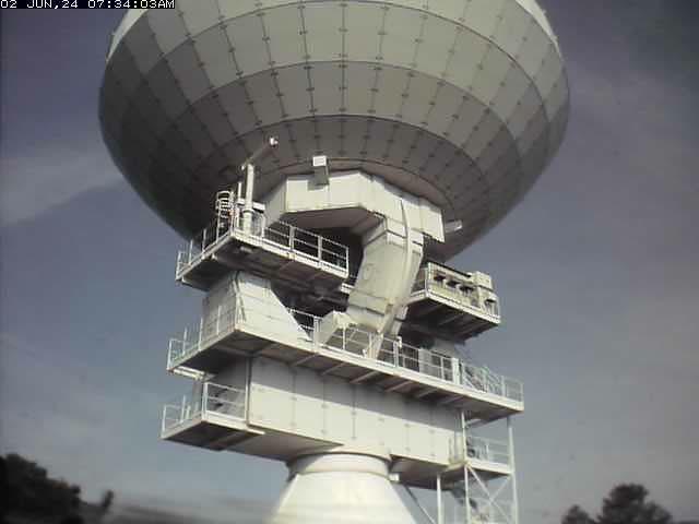 A large satellite dish sitting on top of a building