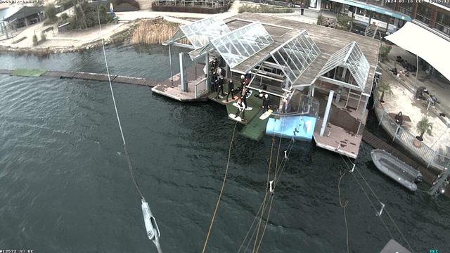 An aerial view of a boat dock with a white awning