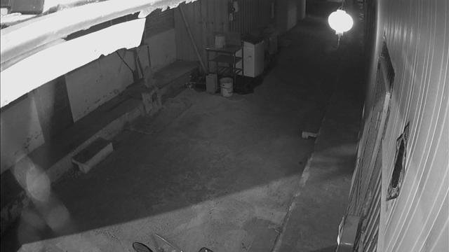 A black and white photo of a person in a garage