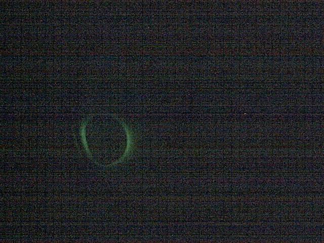 A blurry image of a green object in the dark