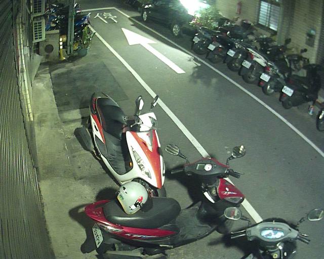 A motorcycle parked on the side of a road next to a car