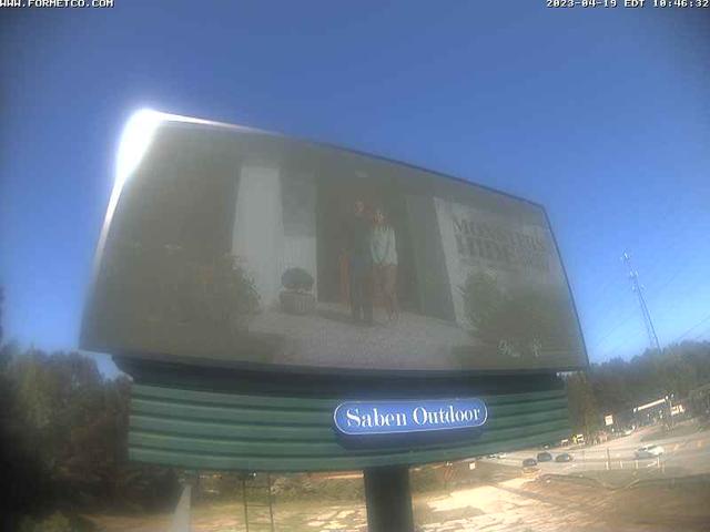 A billboard with a reflection of two people in it
