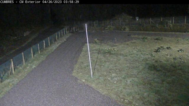 A webcam image of a road at night