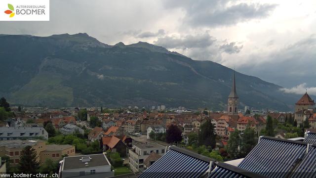 A picture of a city with mountains in the background