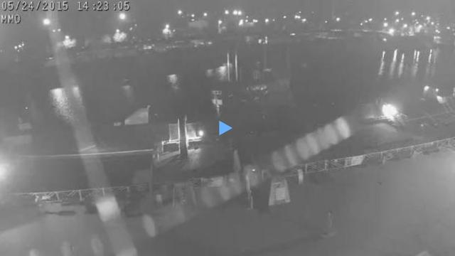 A webcam image of a harbor at night