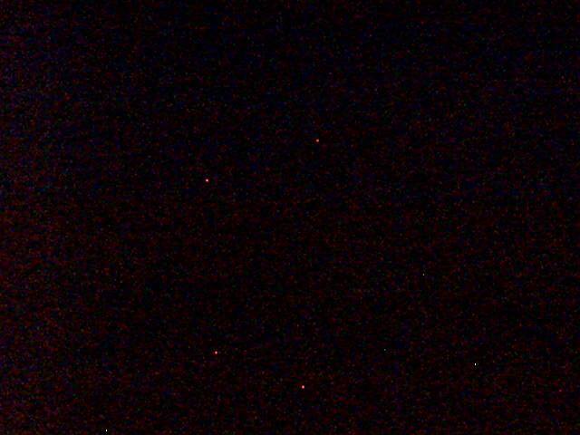 A dark sky with a few stars in it