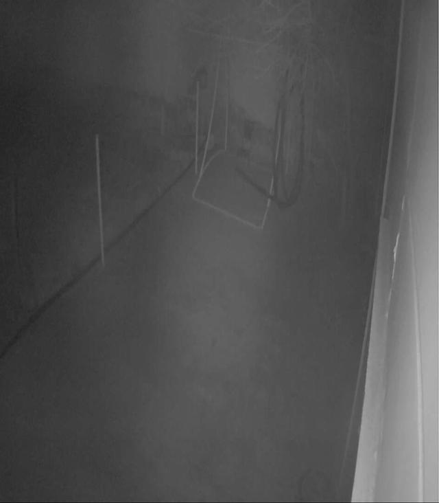 A black and white photo of a foggy hallway