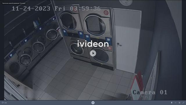 A man standing in front of a washer next to a dryer