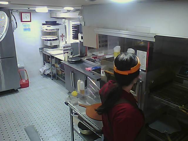 A man in an industrial kitchen preparing food