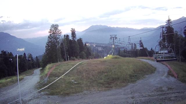 A ski lift going up a hill in the mountains