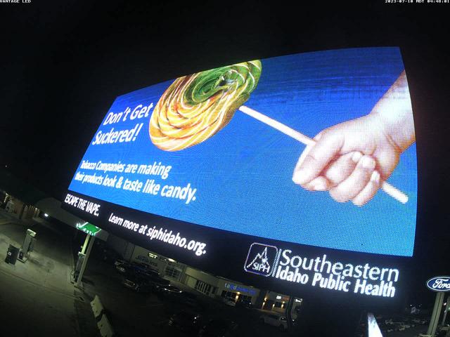 A large screen with a picture of a hand holding a stick