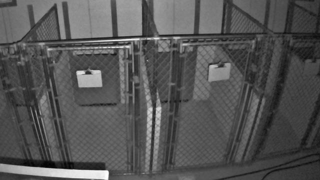 A black and white photo of a jail cell