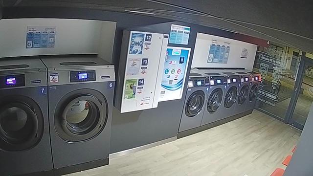 A laundry room with washers and dryers in it