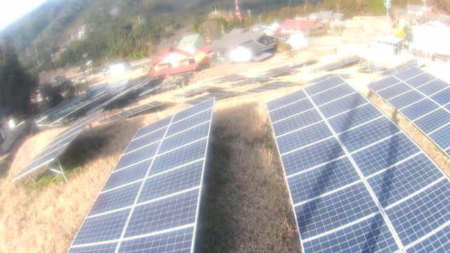 An aerial view of solar panels in a field
