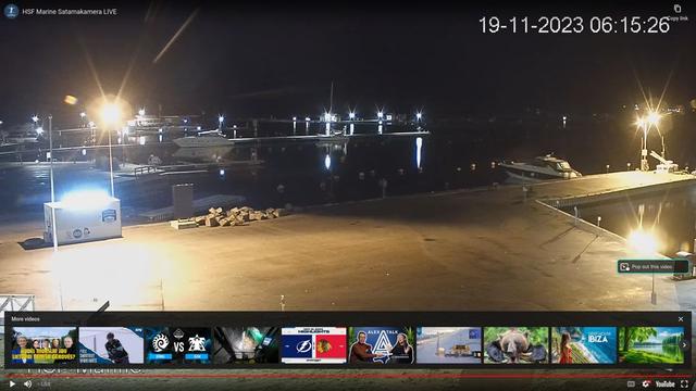 A webcam image of a marina at night