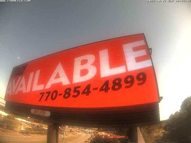 A large red sign that says available on it