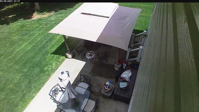An aerial view of a house with a covered patio