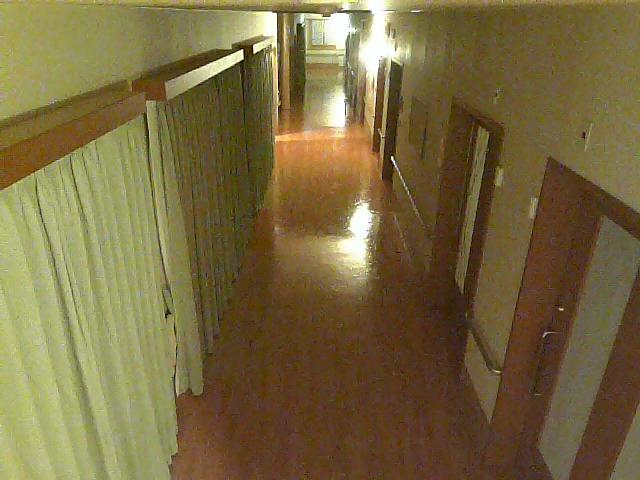 A person in a wheel chair walking down a hallway