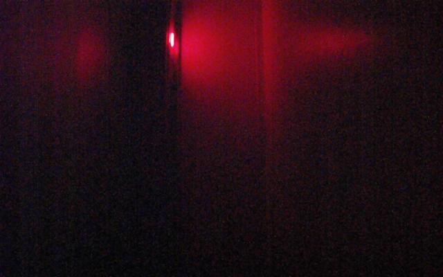 A blurry photo of a red light in a dark room