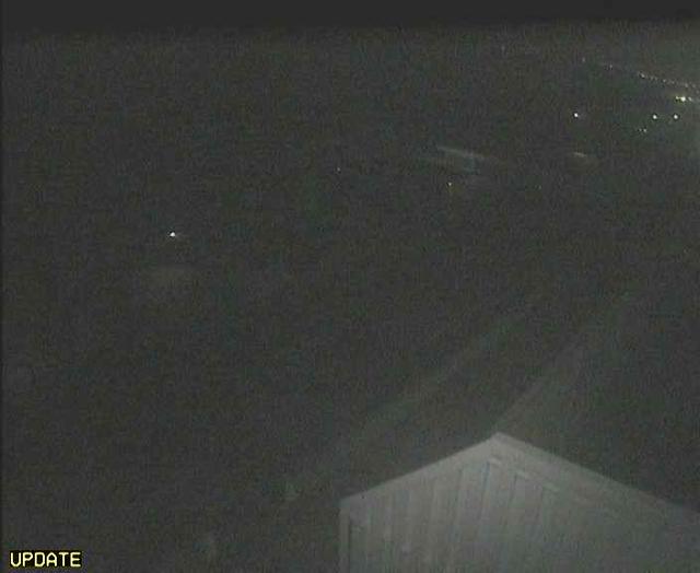 A webcam image of a parking lot at night