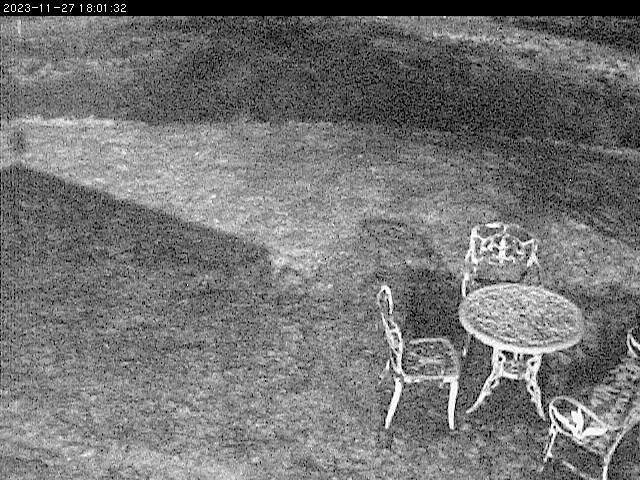 A picture of a table and chairs in a yard