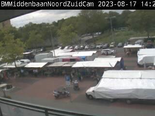 A blurry photo of a parking lot full of tents