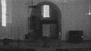 A black and white photo of a door and windows