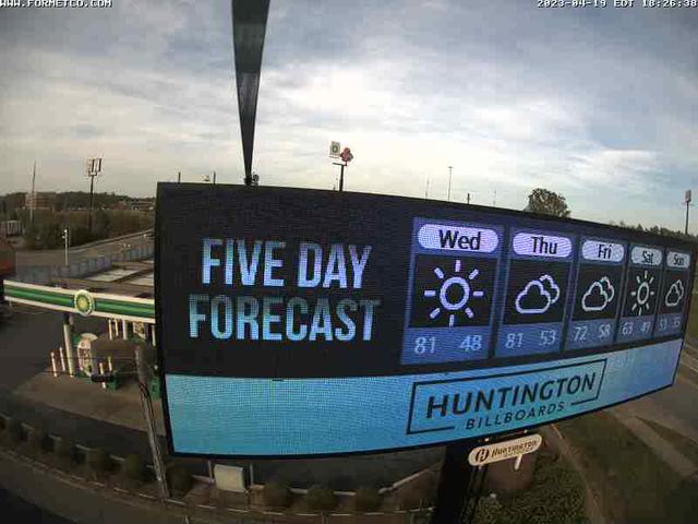 A large screen displaying the weather in a parking lot