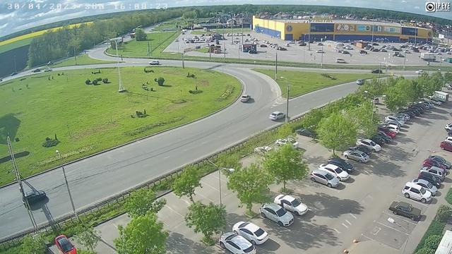 An aerial view of a parking lot with cars parked in it